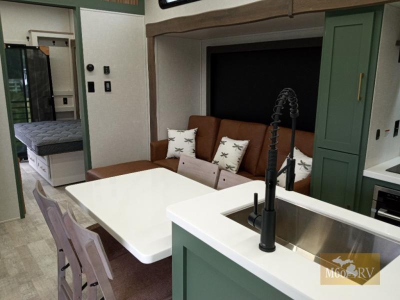 2025 Forest River RV No Boundaries RV Suite RVS3 interior view with seating, kitchen island, and rear bedroom